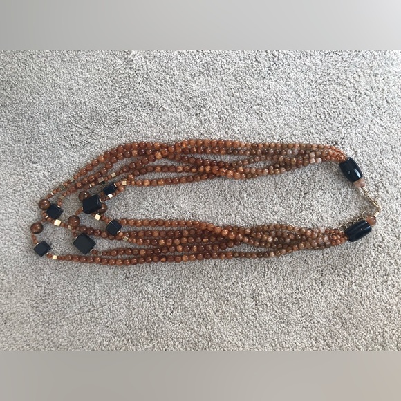 Multi strand necklace of amber colored beads, with navy blue and gold accents - Picture 1 of 4